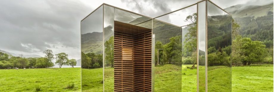 mirrored-lookout-surrounded-by-trees-and-mountains