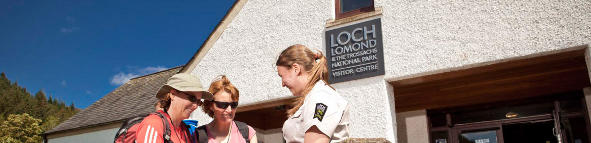 volunteer-helping-visitors-outside-visitor-centre