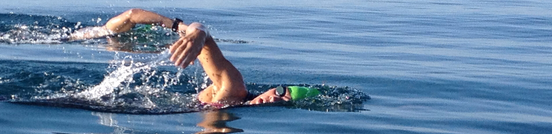 two-people-swimming-in-loch-with-ripples-very-visible-on-surface