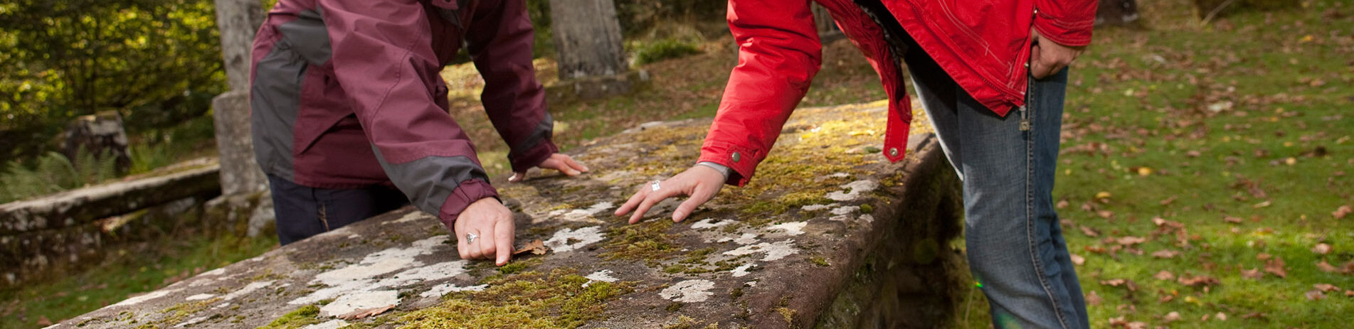 people-looking-at-ancient-burial-stone