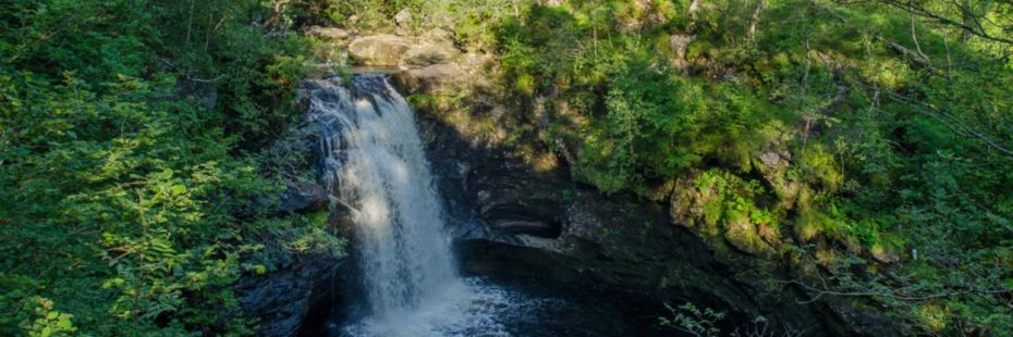 falls-of-falloch-surrounded-by-lush-forest-in-summer