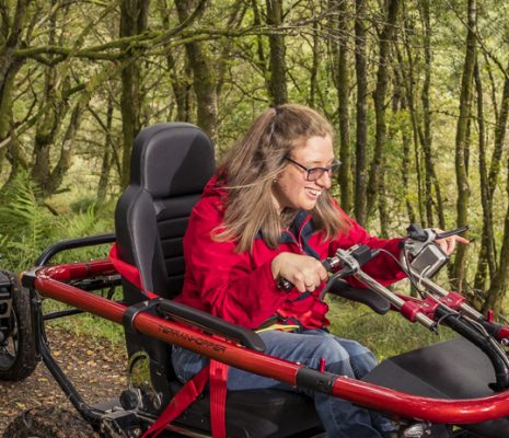 man-and-woman-riding-mobility-scooters-on-forest-path-near-callander