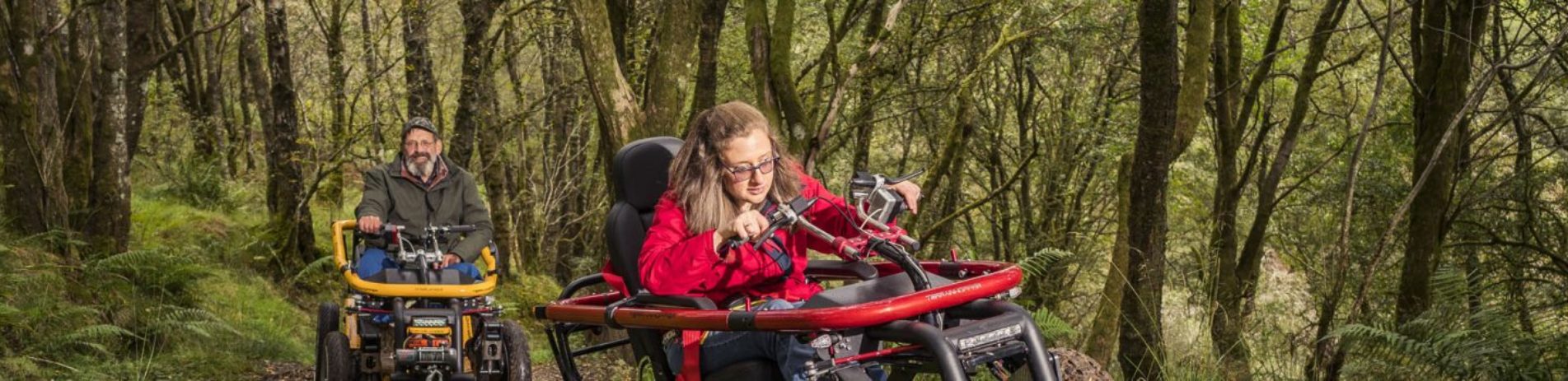 man-and-woman-on-mobility-scooters-in-bracklinn-forest