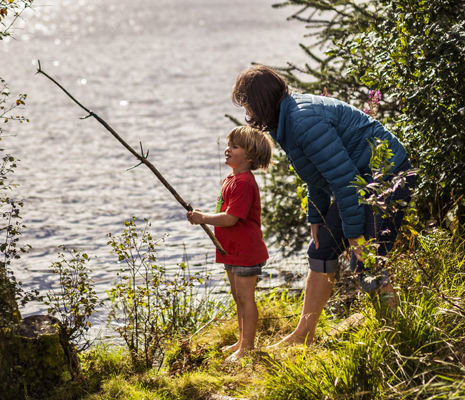 loch lomond day visit mother-and-child-at-edge-of-loch-drunkie-both-barefoot-boy-is-holding-a-long-stick-mock-fishing-rod