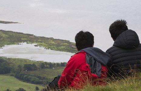 group-of-three-boys-on-hill-slope-looking-down-on-loch-lomond