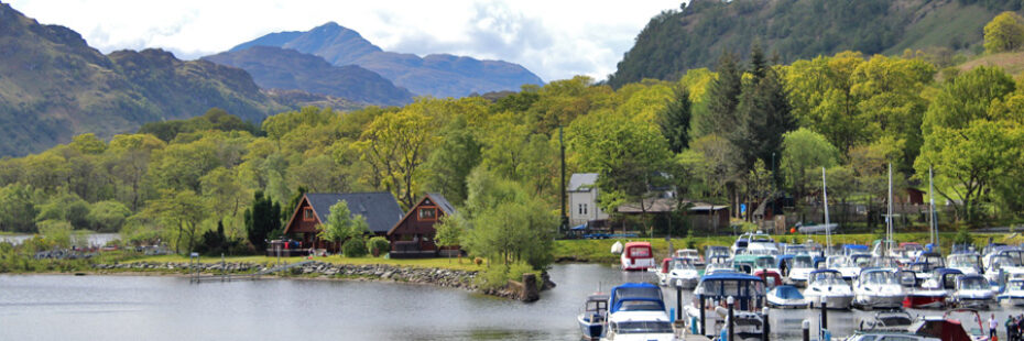 ardlui-marina-and-holiday-chalets-on-side-of-loch-with-ben-lomond-towering-in-the-background