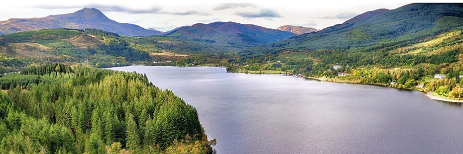 loch-ard-with-surrounded-by-coniferous-forests-and-hills-with-ben-lomond-towering-above-on-left