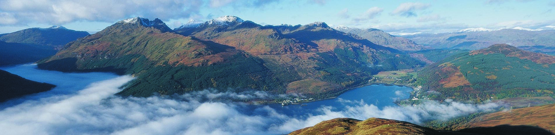 panoramic-view-of-arrochar-alps-mountains-shrouded-in-mist-with-arrochar-village-at-head-of-loch-long-on-the-right