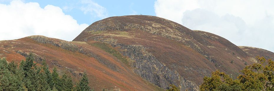 close-up-of-conic-hill-on-east-loch-lomond-from-below-with-forest-canopy-visible-at-the-very-bottom-of-picture