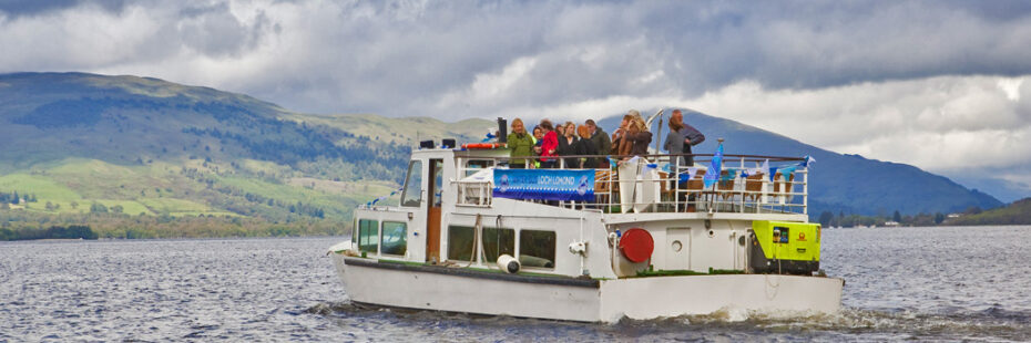 sailing-tourist-boat-on-loch-and-cloudy-day