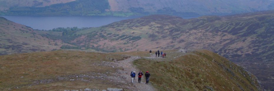 hikers-walking-uphill-on-ben-vorlich-path-loch-earn-visible-behind