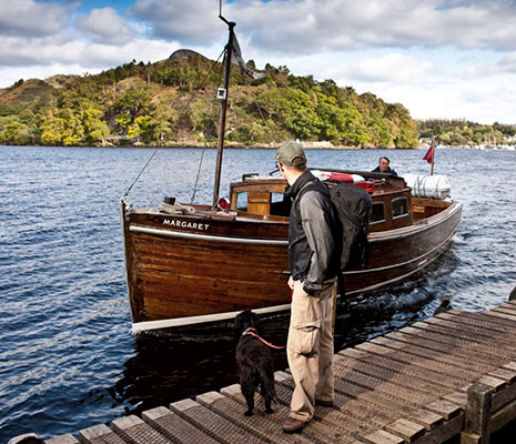 man-standing-with-dog-on-a-pier