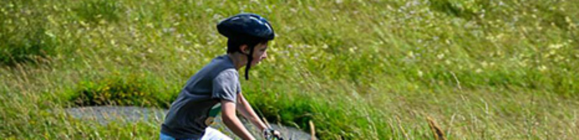young-boy-cycling-in-grassland