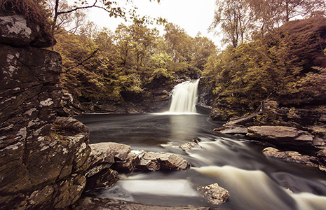 waterfall-with-rocks-and-trees-on-reiverbank