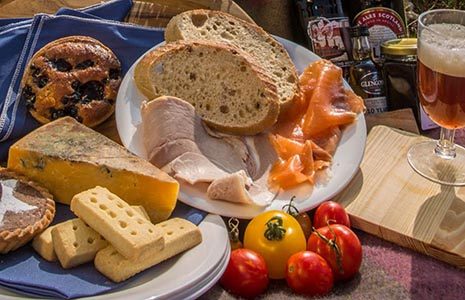 picnic-platter-cheese-selection-shortbread-ham-tomatoes-ales-and-cookies