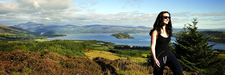 girl-walking-with-panoramic-view-loch-lomond-background