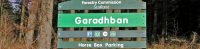 forestry-commission-green-wooden-sign-reading-garadhban-horse-box-parking-with-forest-behind