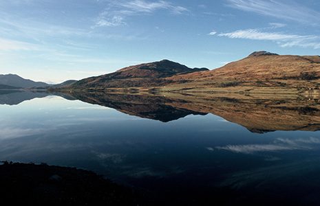 still-area-water-with-reflection-hills