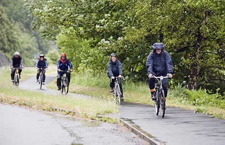 five-cyclists-on-cycle-path-whilst-raining