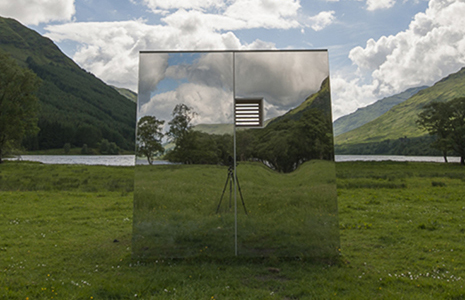 mirrored-cabin-reflections-of-hills-and-loch