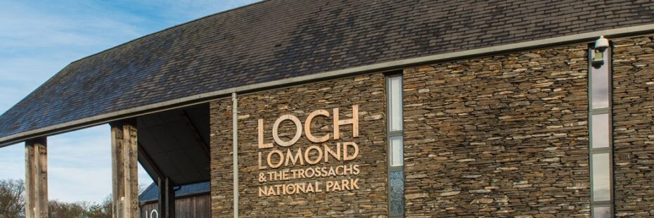 loch-lomond-and-trossachs-national-park-authority-headquarters-building-made-of-stone-and-with-slate-roof-logo-prominent-next-to-entrance