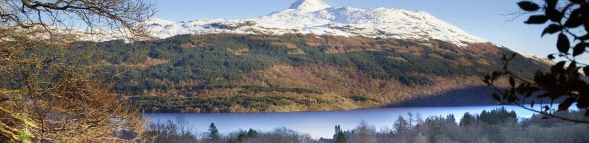 snow-covered-mountain-loch-and-train