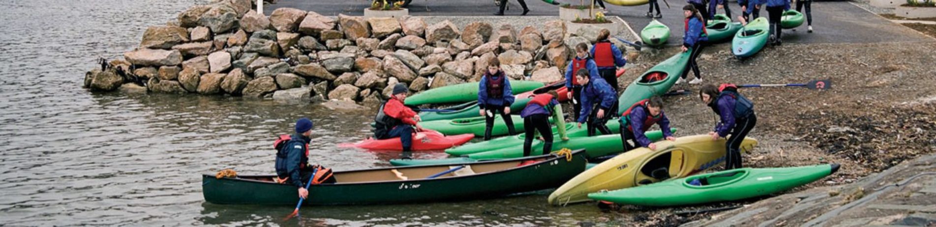 children-with-canoes-getting-into-water