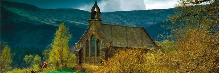 church-surrounded-by-trees-and-mountains