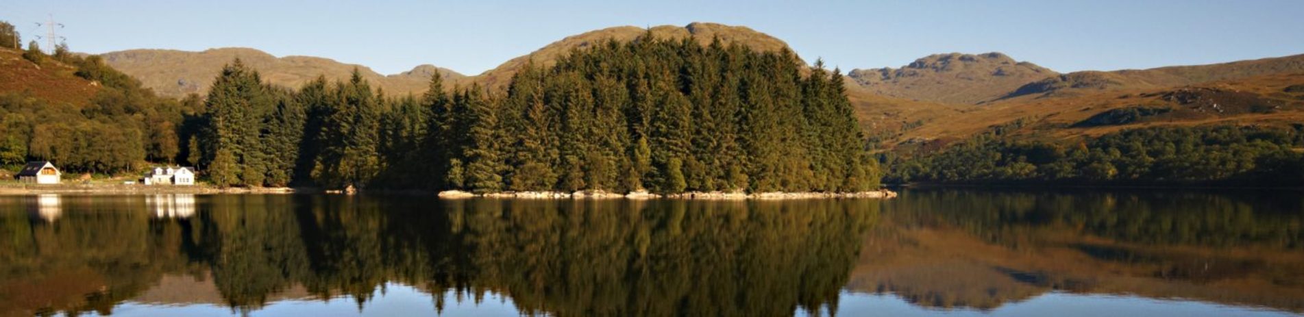 panoramic-loch-forest-blue-sky-and-mountains