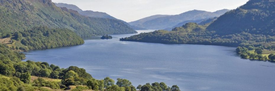 panoramic-of-loch-and-tree-covered-mountains