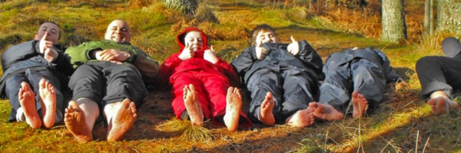 six-people-lying-on-forest-ground-with-bare-feet
