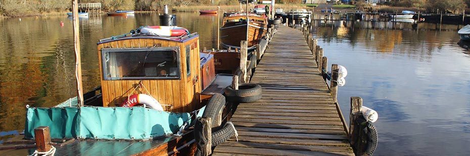 boats-moored-at-balmaha-pier-mirror-like-surface-of-water