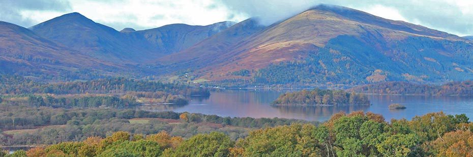 view-of-luss-hills-and-loch-lomond-islands-covered-by-dense-autumn-coloured-native-woods-from-inchcailloch-island-summit