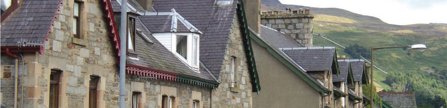 killin-village-main-street-front-victorian-stone-houses-with-sleet-roofs-high-hills-visible-behind-on-right