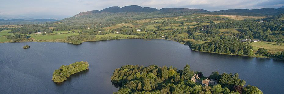 aerial-view-of-lake-of-menteithw-with-medieval-abbey-ruins-visible-on-island-in-foreground