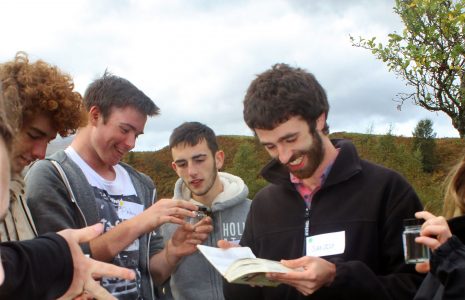 young-men-laughing-and-identifying-small-wildlife