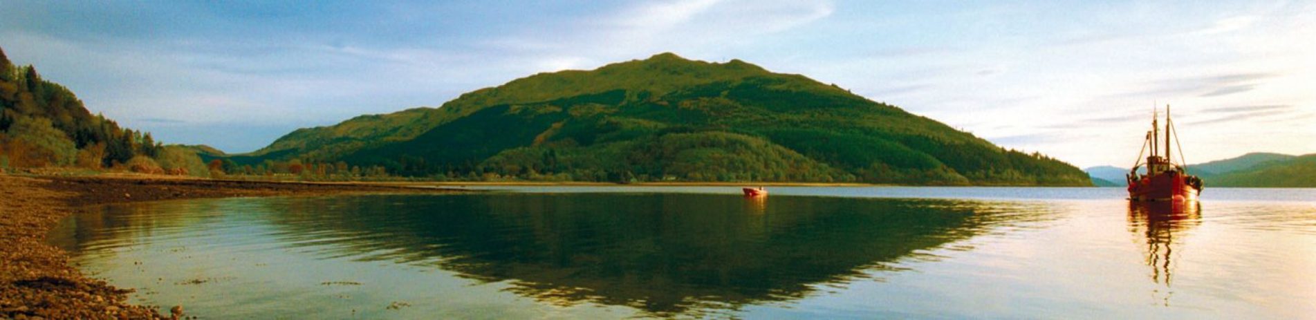 ardentinny-shore-view-of-loch-long-and-moored-boats-mirror-like-surface-and-blue-skies