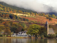 port-of-menteith-village-and-church-on-shore-of-lake-of-menteith-in-autumn-stunning-colours