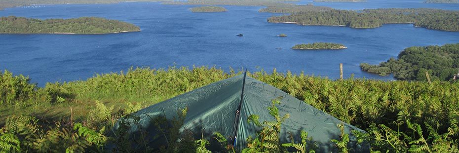 green-tent-in-bracken-on-luss-hills-with-stunning-view-of-loch-lomond-and-forested-islands-behind