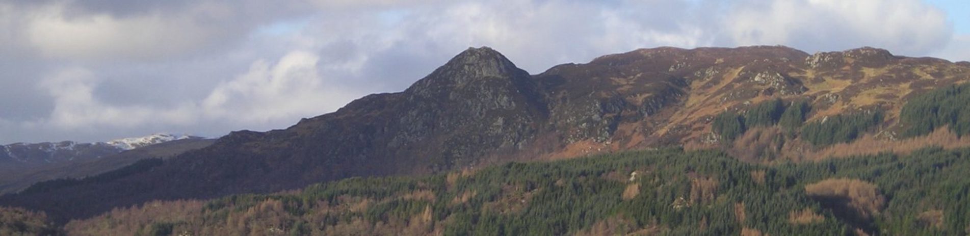 ben-aan-towering-above-surrounding-crags-with-coniferous-forests-on-its-slopes