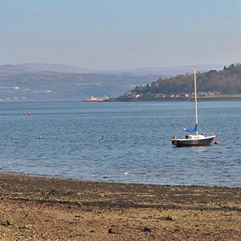 holy-loch-beach-with-moored-boat-and-firth-of-clyde-in-the-distance