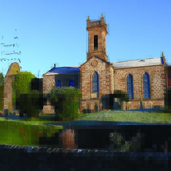 kilmun-victorian-church-with-light-smattering-of-snow-on-roof-and-grass-lawn-blue-skies-above