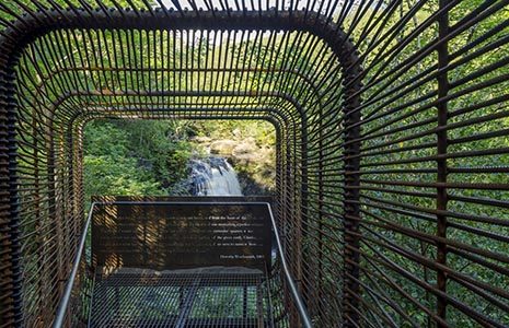 woven-sound-art-installation-tunnel-made-of-forged-iron-wires-with-falls-of-falloch-and-lots-of-vegetation-beyond