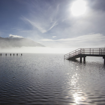 tarbet-pier-ben-lomond-peeking-through-mists-blue-skies-above-clouds