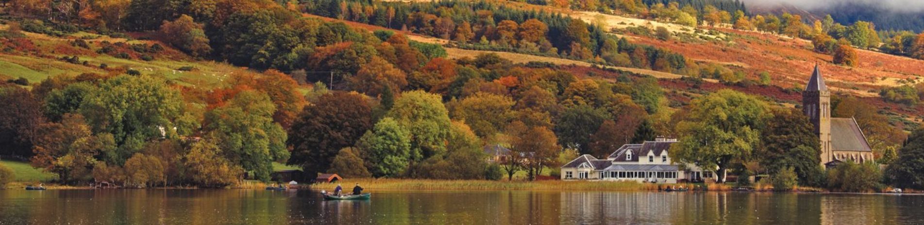 stunning-autumnal-landscape-of-lake-of-menteith-and-port-of-menteith-village-on-the-shore