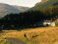 glen-massan-path-in-sunset-light-farm-house-in-distance-next-to-coniferous-plantation