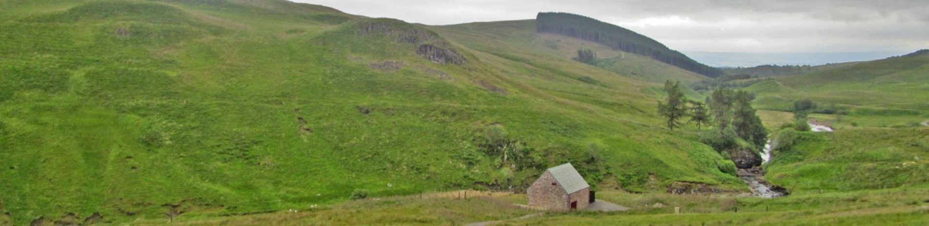 keltie-water-hydro-scheme-main-building-by-stream-surrounded-by-hills