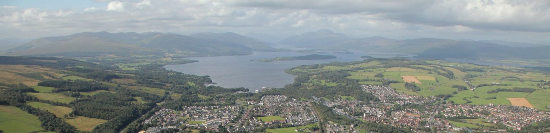 aerial-view-of-balloch-and-south-shore-of-loch-lomond-with-mountains-in-the-distance