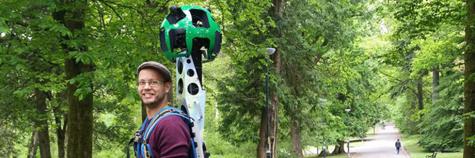 young-man-with-mounted-google-street-view-camera-on-his-back-in-balloch-vastle-country-park-on-main-path