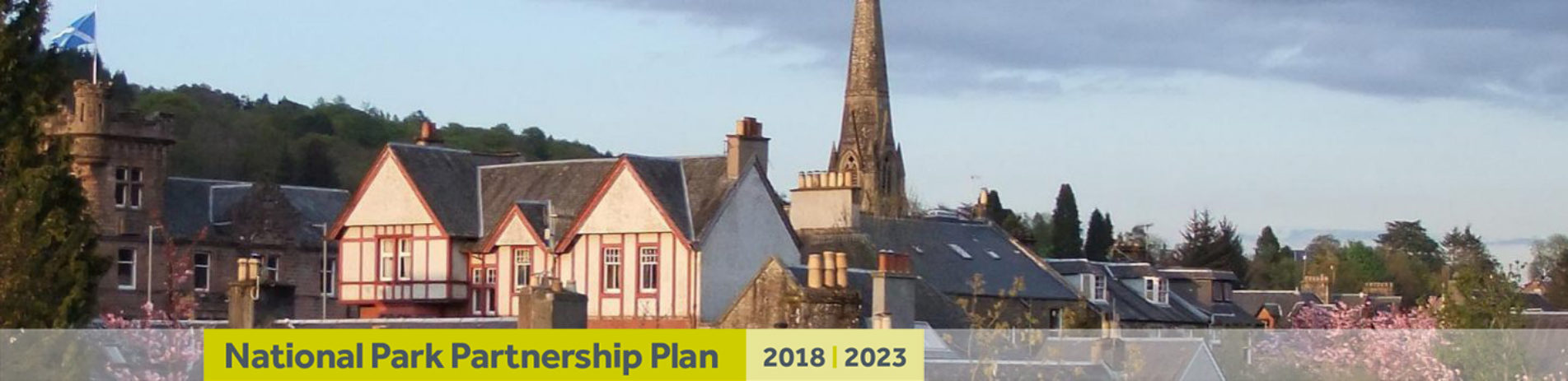 callander-town-houses-and-church-spire-with-banner-underneath-reading-national-park-partnership-plan-two-thousand-eighteen-two-thousand-twenty-three